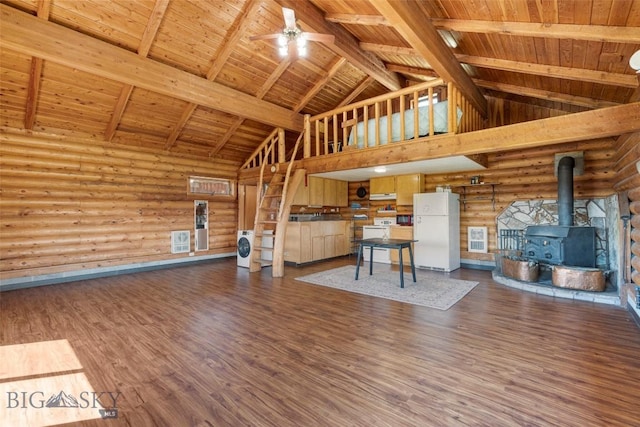 3500 Jackson Creek Rd, Bozeman, MT 59715 - unfurnished living room featuring a wood ceiling with exposed beams, high vaulted ceiling, a wood stove, a ceiling fan, and rustic walls