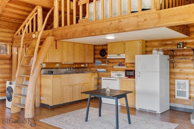 3500 Jackson Creek Rd, Bozeman, MT 59715 - kitchen featuring white appliances, under cabinet range hood, rustic walls, light brown cabinets, and washer / dryer