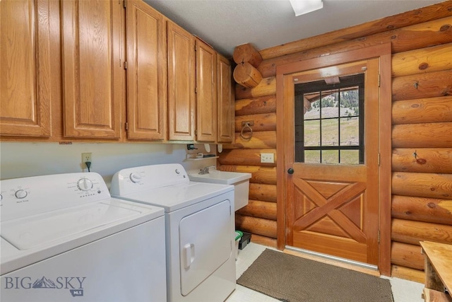 3500 Jackson Creek Rd, Bozeman, MT 59715 - laundry area featuring rustic walls, washer and clothes dryer, and cabinet space