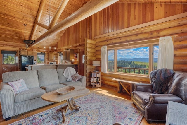 3500 Jackson Creek Rd, Bozeman, MT 59715 - living area featuring a wooden ceiling with exposed beams, rustic walls, light wood finished floors, high vaulted ceiling, and a mountain view