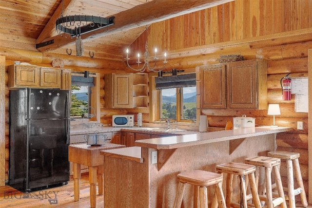 3500 Jackson Creek Rd, Bozeman, MT 59715 - kitchen featuring freestanding refrigerator, rustic walls, open shelves, a peninsula, and healthy amount of natural light