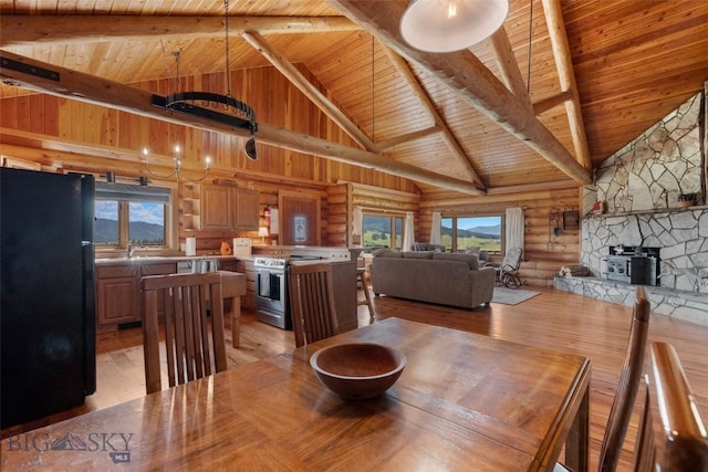 3500 Jackson Creek Rd, Bozeman, MT 59715 - dining room featuring a wooden ceiling with exposed beams, light wood-style flooring, plenty of natural light, rustic walls, and high vaulted ceiling