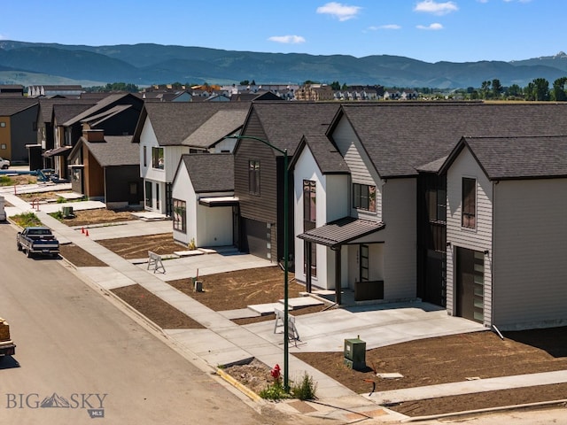 2809 S 30th Ave, Bozeman, MT 59718 - view of front facade with driveway, a garage, a mountain view, and a residential view