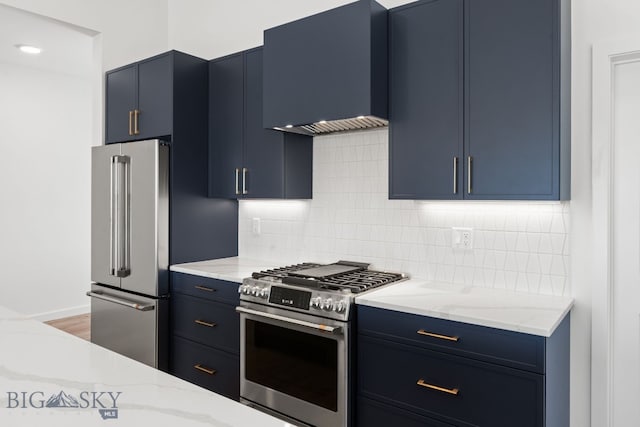 2809 S 30th Ave, Bozeman, MT 59718 - kitchen featuring stainless steel appliances, blue cabinets, ventilation hood, tasteful backsplash, and light stone counters