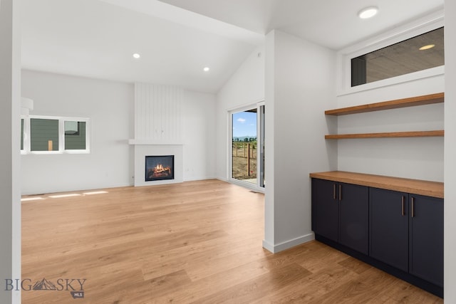 2809 S 30th Ave, Bozeman, MT 59718 - unfurnished living room with a fireplace, light wood-style flooring, lofted ceiling, and recessed lighting