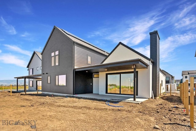 2809 S 30th Ave, Bozeman, MT 59718 - back of house featuring a patio and a chimney