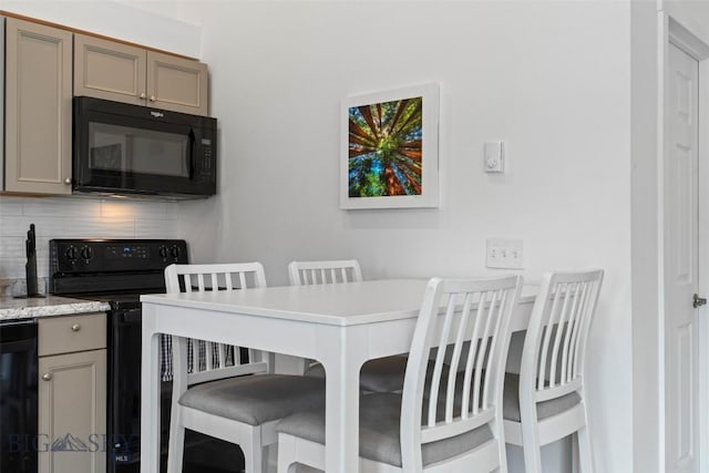 402 Brookline St Unit B, Livingston, MT 59047 - kitchen featuring black appliances, backsplash, gray cabinetry, and a breakfast bar area