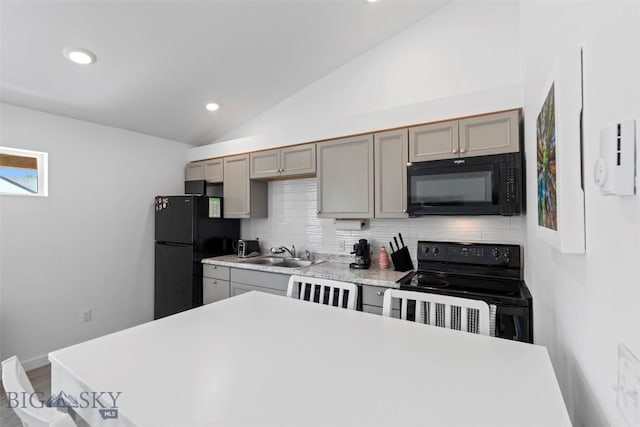 402 Brookline St Unit B, Livingston, MT 59047 - kitchen with black appliances, vaulted ceiling, gray cabinetry, backsplash, and light countertops