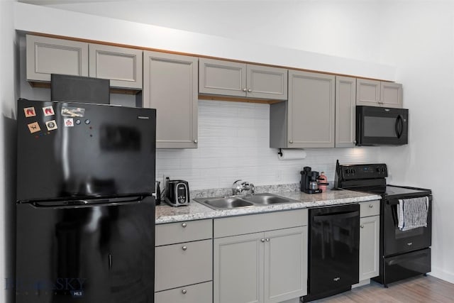 402 Brookline St Unit B, Livingston, MT 59047 - kitchen featuring black appliances, gray cabinetry, tasteful backsplash, and light countertops