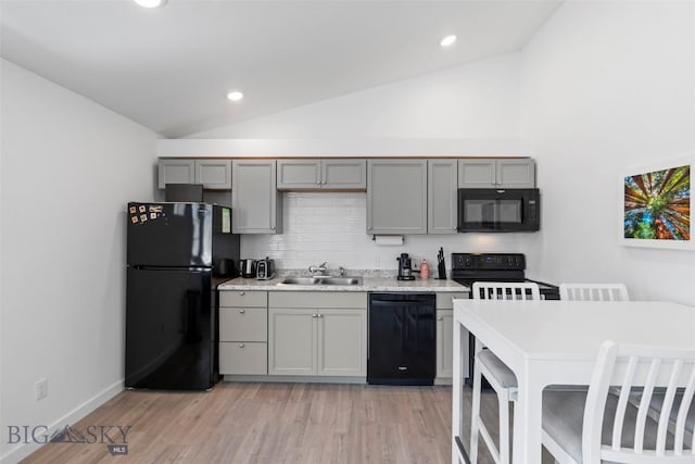 402 Brookline St Unit B, Livingston, MT 59047 - kitchen with black appliances, gray cabinets, vaulted ceiling, backsplash, and light wood finished floors