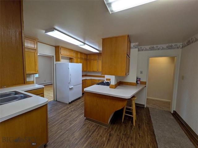 944 Placer, Butte, MT 59701 - kitchen with freestanding refrigerator, a peninsula, a baseboard heating unit, and light countertops