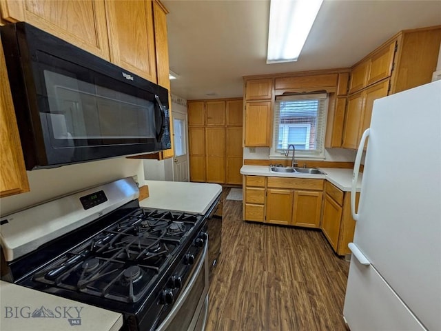 944 Placer, Butte, MT 59701 - kitchen featuring freestanding refrigerator, gas range, black microwave, dark wood-type flooring, and light countertops