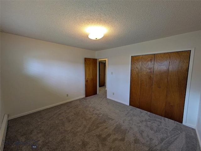 944 Placer, Butte, MT 59701 - unfurnished bedroom with carpet flooring, a closet, a textured ceiling, and baseboard heating