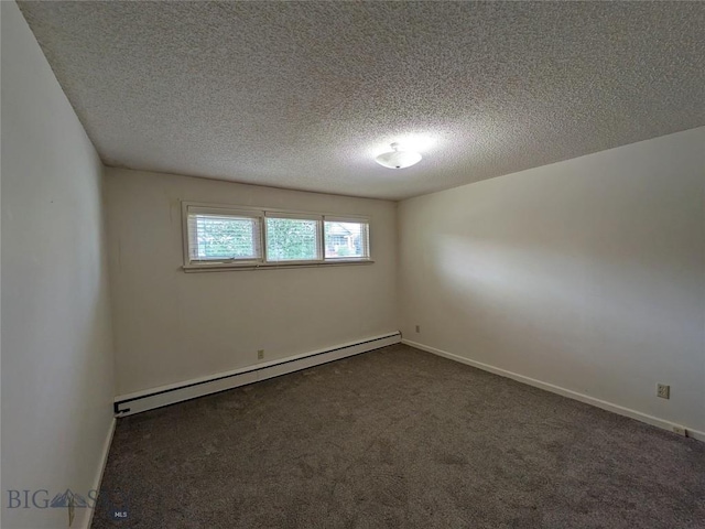 944 Placer, Butte, MT 59701 - spare room featuring a baseboard radiator, dark colored carpet, and a textured ceiling