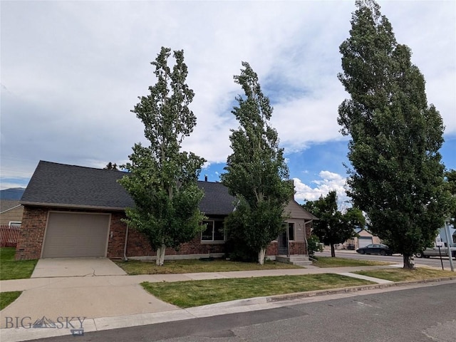 944 Placer, Butte, MT 59701 - view of property hidden behind natural elements with concrete driveway, brick siding, a garage, and a shingled roof