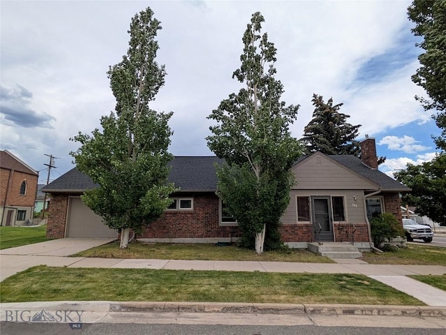 944 Placer, Butte, MT 59701 - view of front of property featuring brick siding, concrete driveway, a front lawn, and an attached garage