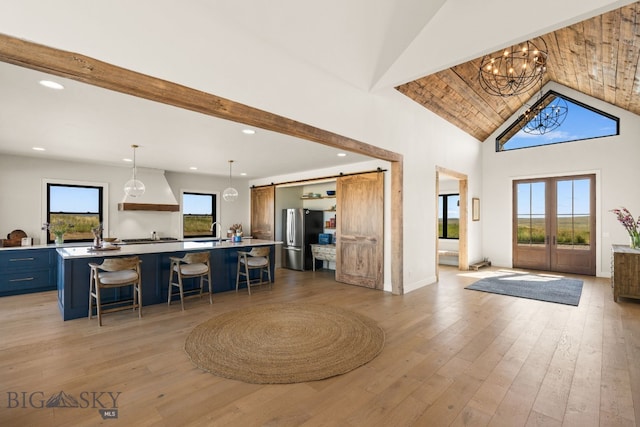 120 Horseshoe Loop, Harrison, MT 59735 - foyer entrance featuring a barn door, light wood-style flooring, recessed lighting, high vaulted ceiling, and a chandelier