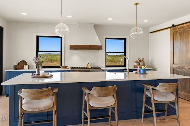 120 Horseshoe Loop, Harrison, MT 59735 - kitchen featuring custom exhaust hood, light countertops, healthy amount of natural light, and recessed lighting