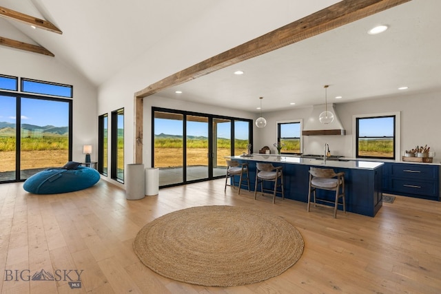 120 Horseshoe Loop, Harrison, MT 59735 - kitchen with light wood-style floors, a breakfast bar area, a kitchen island with sink, open floor plan, and recessed lighting
