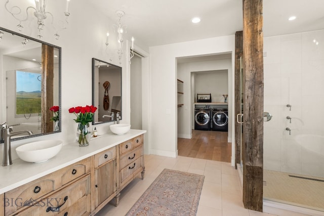 120 Horseshoe Loop, Harrison, MT 59735 - bathroom with washer and dryer, double vanity, a stall shower, tile patterned floors, and recessed lighting