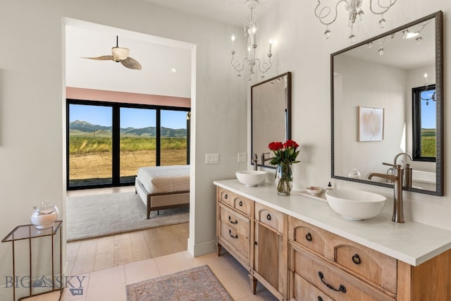 120 Horseshoe Loop, Harrison, MT 59735 - ensuite bathroom with double vanity, a mountain view, and a chandelier