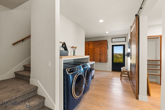 120 Horseshoe Loop, Harrison, MT 59735 - washroom featuring washer and clothes dryer, recessed lighting, a barn door, and light wood finished floors
