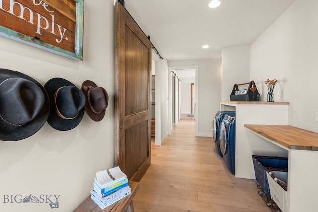 120 Horseshoe Loop, Harrison, MT 59735 - hall featuring independent washer and dryer, recessed lighting, a barn door, and light wood-type flooring