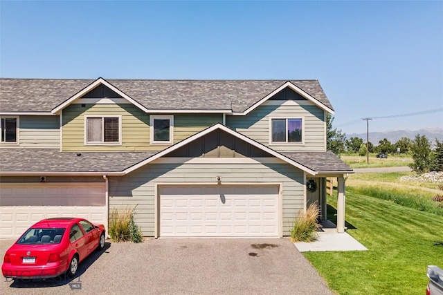 160 Tail Feather Ln Unit D, Bozeman, MT 59718 - view of property with driveway, an attached garage, a front lawn, and a shingled roof