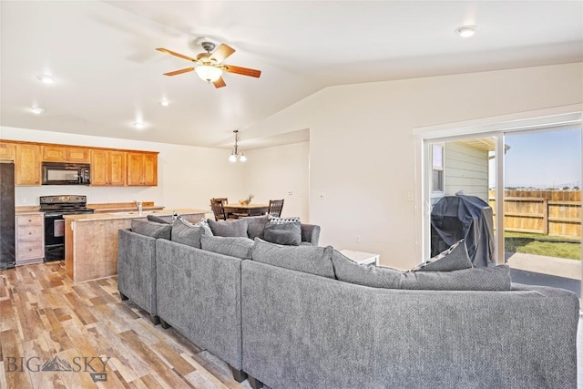 160 Tail Feather Ln Unit D, Bozeman, MT 59718 - living room featuring lofted ceiling, ceiling fan, and light wood-style flooring