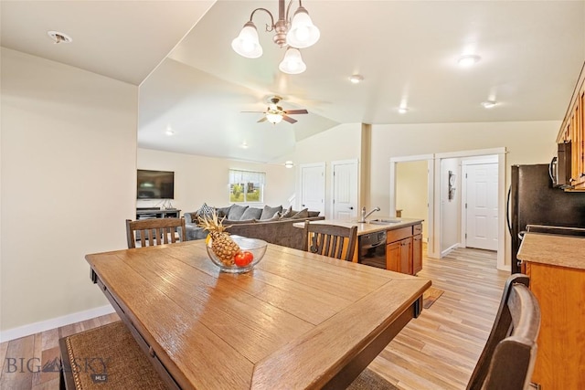 160 Tail Feather Ln Unit D, Bozeman, MT 59718 - dining space featuring lofted ceiling, light wood-style flooring, a ceiling fan, and a chandelier