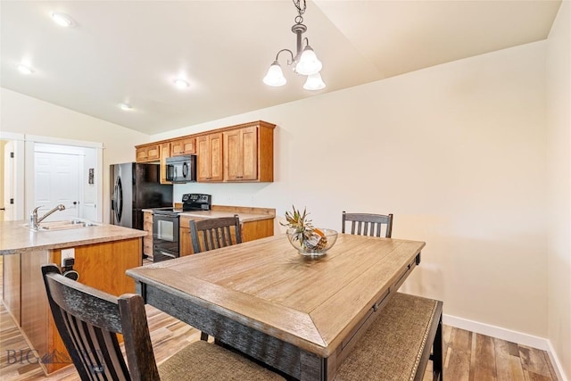 160 Tail Feather Ln Unit D, Bozeman, MT 59718 - dining area with vaulted ceiling, light wood finished floors, a chandelier, and recessed lighting