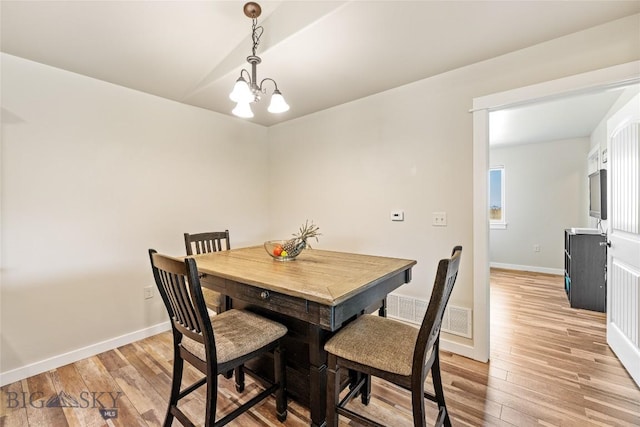 160 Tail Feather Ln Unit D, Bozeman, MT 59718 - dining area with light wood-type flooring and a chandelier