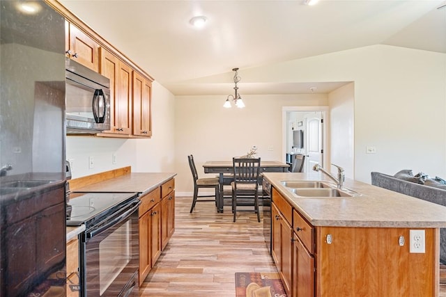 160 Tail Feather Ln Unit D, Bozeman, MT 59718 - kitchen featuring black electric range, lofted ceiling, light wood-style floors, brown cabinets, and pendant lighting
