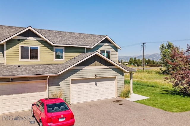 160 Tail Feather Ln Unit D, Bozeman, MT 59718 - view of front of house featuring a shingled roof, a front lawn, a mountain view, and driveway