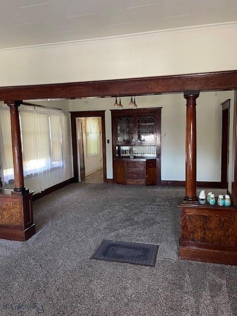 619 Daly St W, Walkerville, MT 59701 - unfurnished living room featuring decorative columns, ornamental molding, and carpet