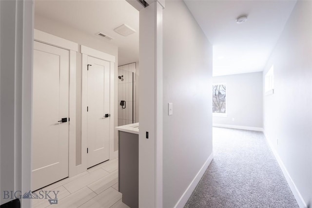 740 Rogers Way Unit B, Bozeman, MT 59718 - hallway with baseboards and light carpet