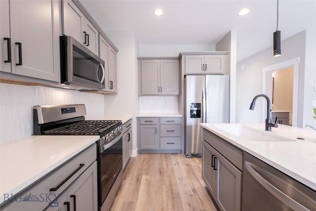 740 Rogers Way Unit B, Bozeman, MT 59718 - kitchen featuring stainless steel appliances, gray cabinets, light wood-style floors, and recessed lighting