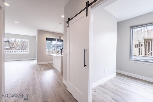 740 Rogers Way Unit B, Bozeman, MT 59718 - corridor featuring a barn door, light wood finished floors, and recessed lighting