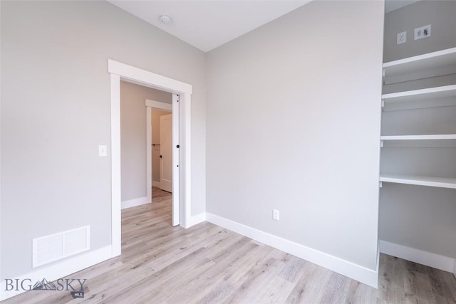 740 Rogers Way Unit B, Bozeman, MT 59718 - unfurnished bedroom featuring wood finished floors and a closet