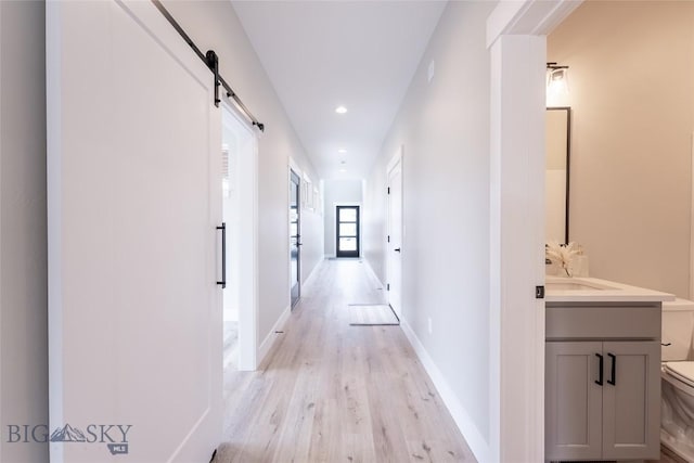 740 Rogers Way Unit B, Bozeman, MT 59718 - corridor featuring light wood-style flooring, recessed lighting, and a barn door