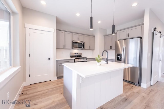 740 Rogers Way Unit B, Bozeman, MT 59718 - kitchen with appliances with stainless steel finishes, gray cabinets, light wood-style flooring, and recessed lighting