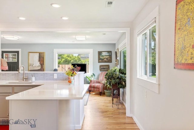 2 Harris Pl, Livingston, MT 59047 - kitchen with healthy amount of natural light, light wood-type flooring, tasteful backsplash, light countertops, and recessed lighting