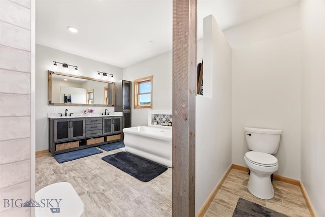 915 Point Of Rocks Rd, Whitehall, MT 59759 - bathroom with wood finished floors, double vanity, and a freestanding tub
