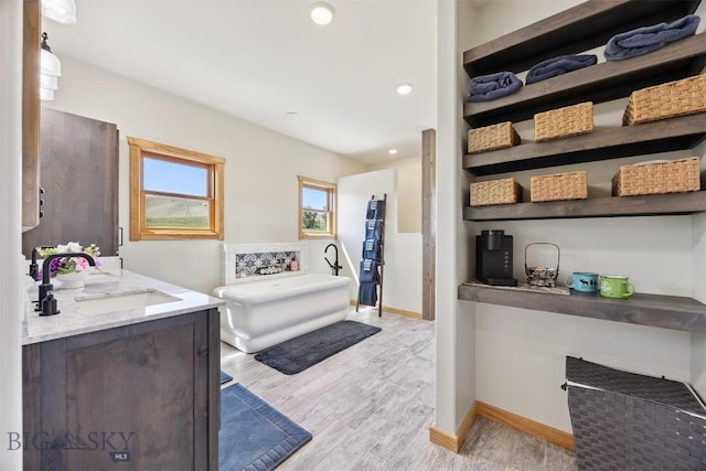 915 Point Of Rocks Rd, Whitehall, MT 59759 - bathroom featuring vanity, a soaking tub, wood finished floors, and recessed lighting