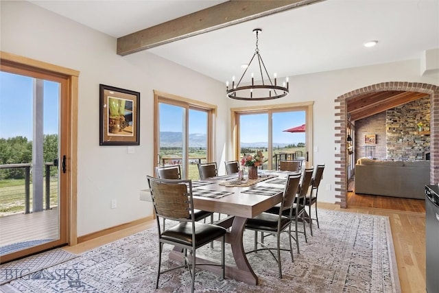 915 Point Of Rocks Rd, Whitehall, MT 59759 - dining space with beam ceiling, a chandelier, light wood-style flooring, a mountain view, and recessed lighting