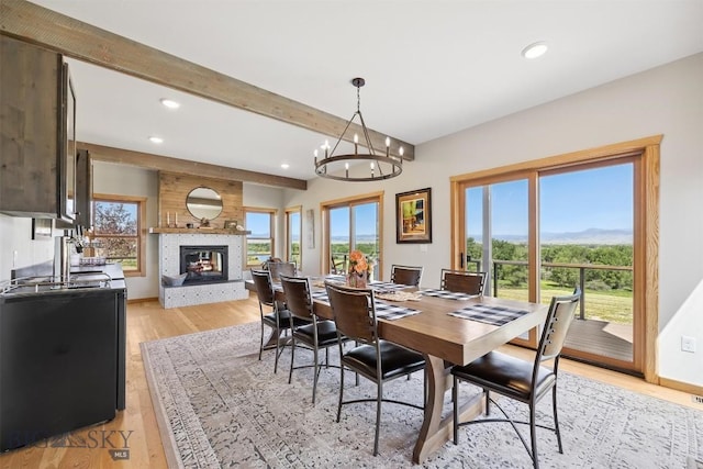 915 Point Of Rocks Rd, Whitehall, MT 59759 - dining area with recessed lighting, a chandelier, a multi sided fireplace, beamed ceiling, and light wood finished floors