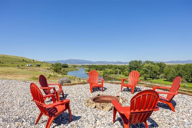 915 Point Of Rocks Rd, Whitehall, MT 59759 - view of patio featuring a fire pit and a water and mountain view