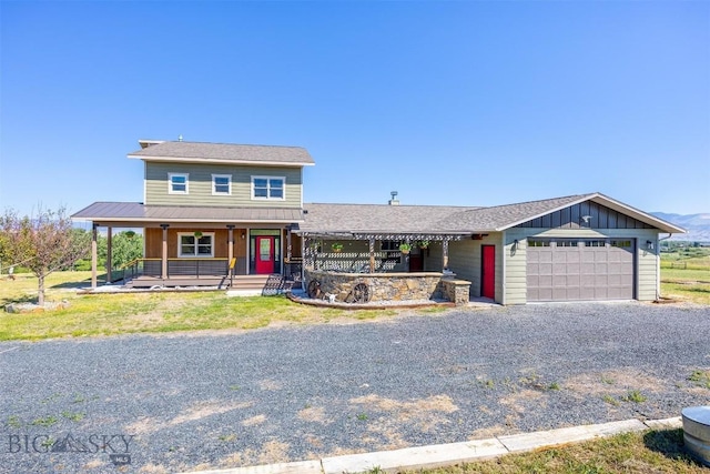915 Point Of Rocks Rd, Whitehall, MT 59759 - view of front of house with a garage, driveway, a porch, and board and batten siding