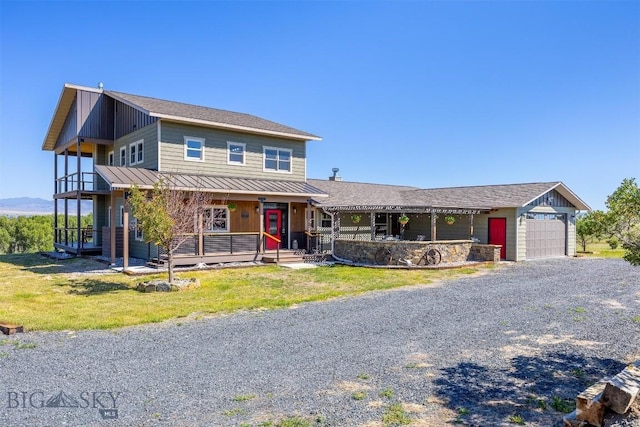 915 Point Of Rocks Rd, Whitehall, MT 59759 - view of front of home with a standing seam roof, a porch, a metal roof, an attached garage, and a front lawn