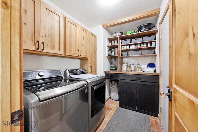 915 Point Of Rocks Rd, Whitehall, MT 59759 - laundry area featuring washing machine and dryer and cabinet space